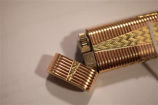 A Cartier two colour gold plated lighter, 2.75in.